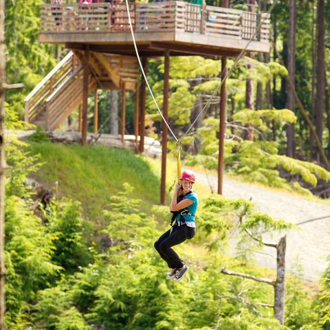 A woman smiles while ziplining