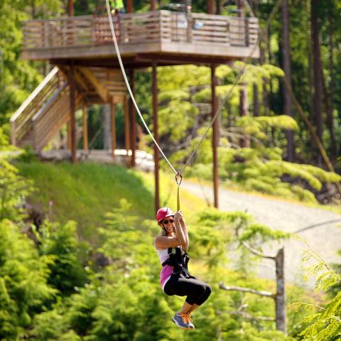 A woman smiles on a High Life Adventures zip line