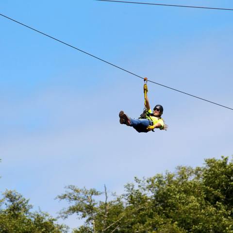 A woman soars on a High Life Adventures zipline