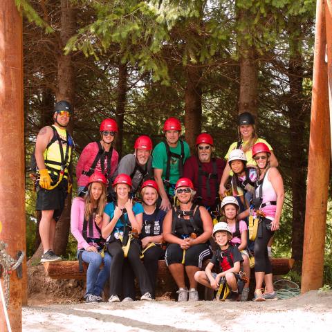 A ziplining group poses for a photo on the course