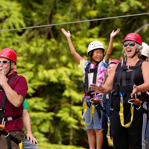 A group cheering on the zip lining course