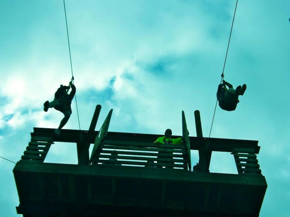 Zipliners take off from the tower on the zipline adventures course