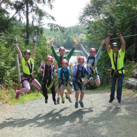 a group of people walking down a dirt road